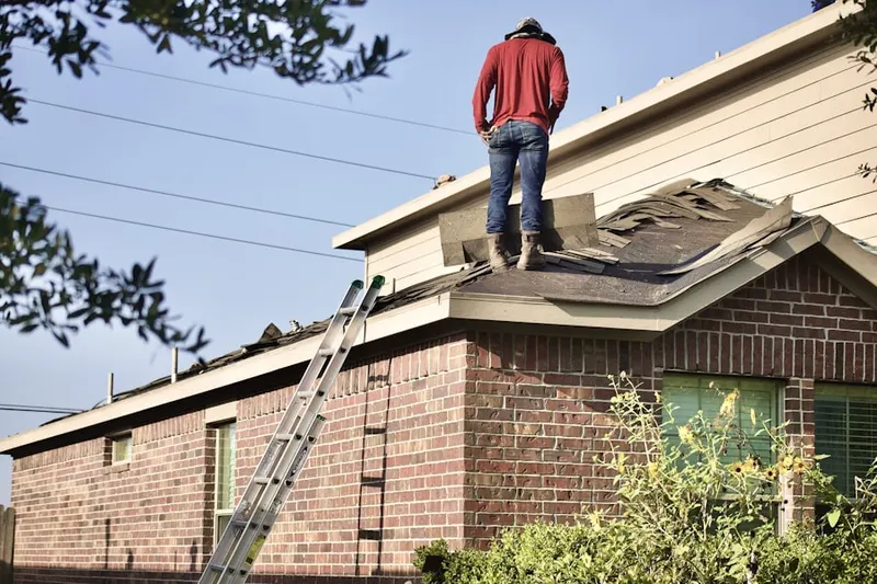 Professional roofer working on a residential roof in Landing